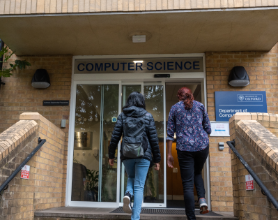 The department reception, with glass doors. Above is a sign that reads 'Computer Science'