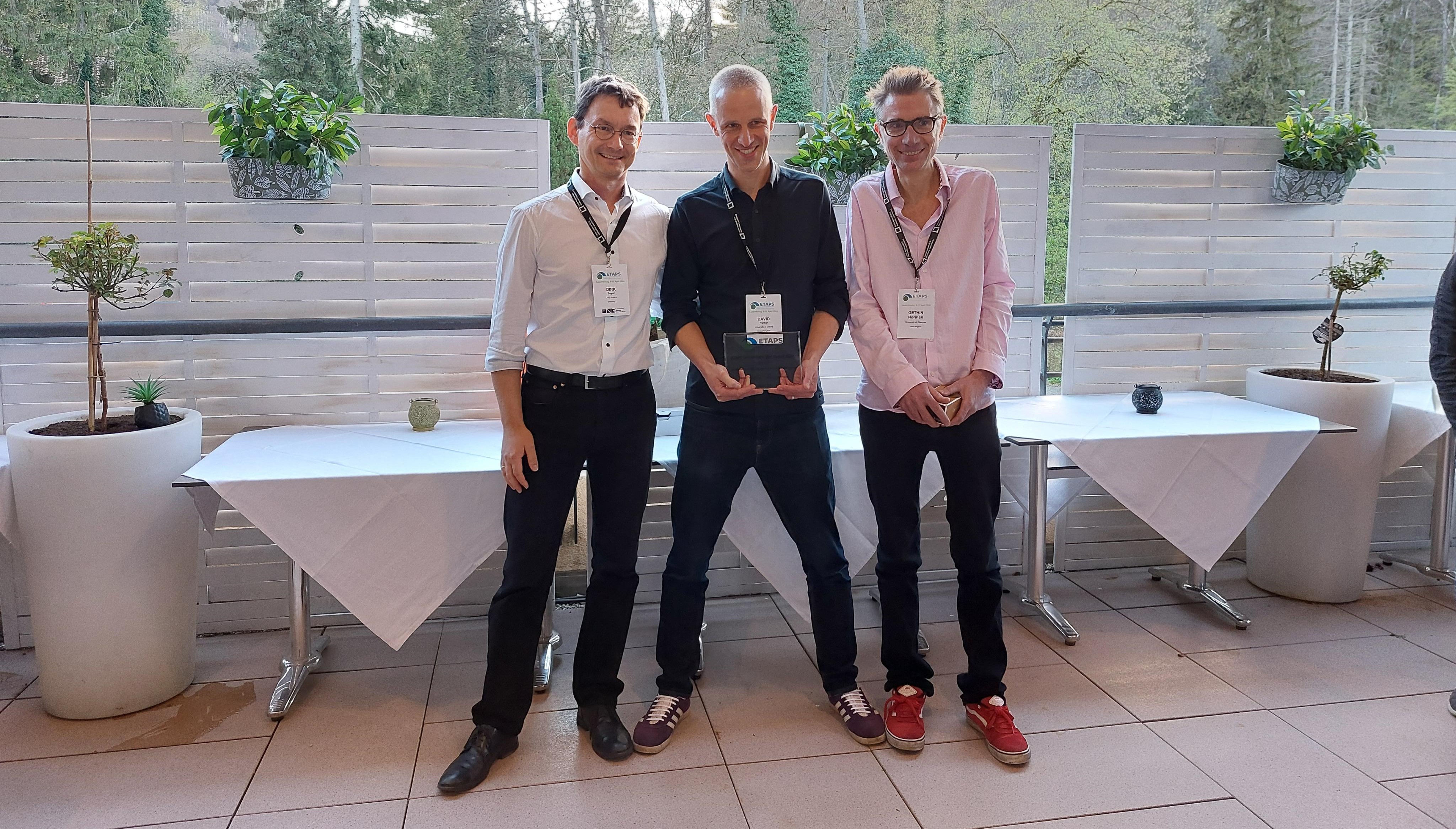 Image showing Professor David Parker (centre), holding the ETAPS award, with Dr Gethin Norman (right) and Dirk Beyer, Chair of the ETAPS Awards Committee (left)