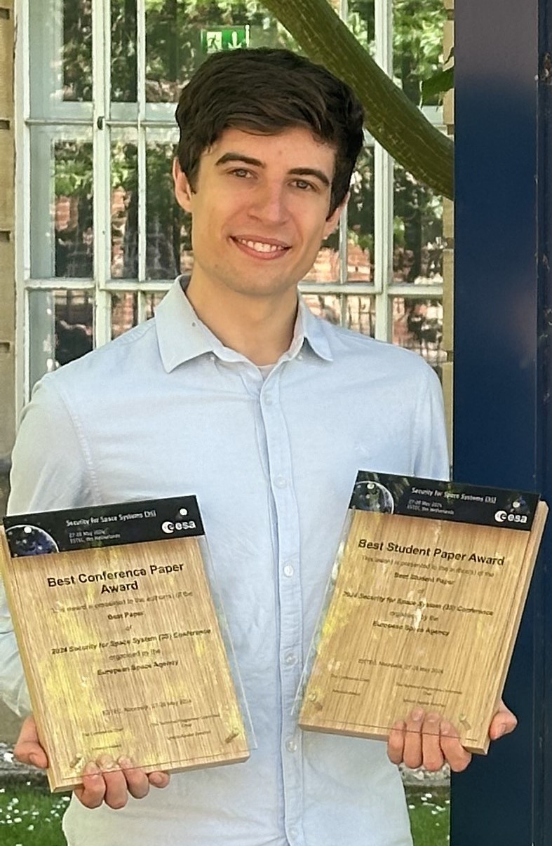 Image showing Edd Salkield holding his two awards.